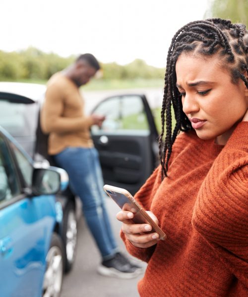 Female Motorist Involved In Car Accident Calling Insurance Company Or Recovery Service Female Motorist Involved In Car Accident Calling Insurance Company Or Recovery Service